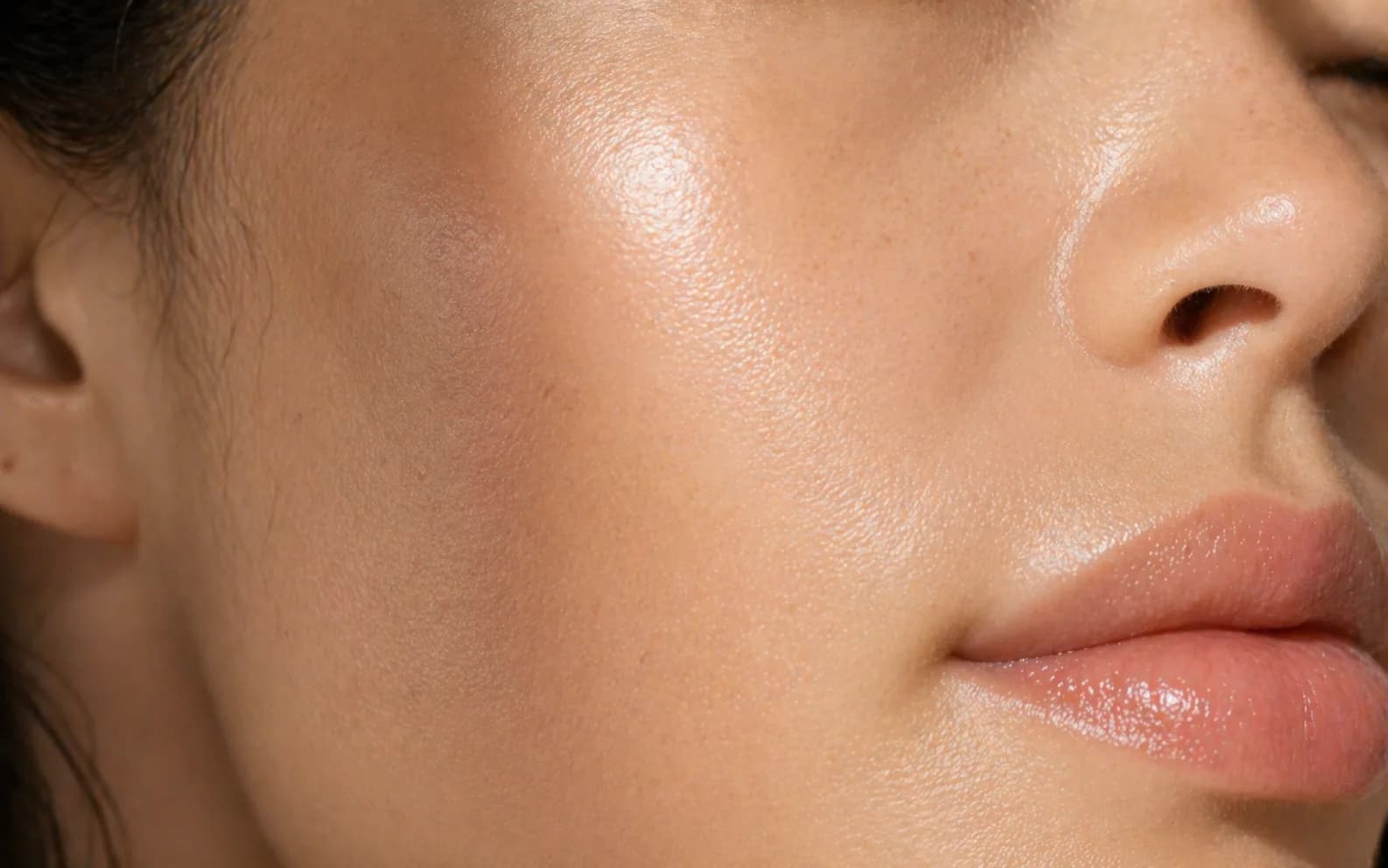 Close-up of refined skin texture with natural pores and soft hydrated glow.